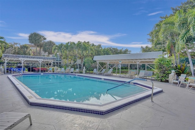 view of pool with a pergola and a patio area