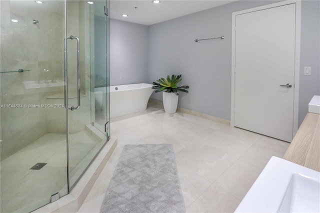 bathroom featuring tile flooring and shower with separate bathtub