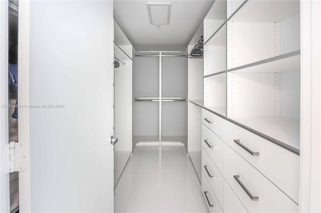 spacious closet featuring light tile floors