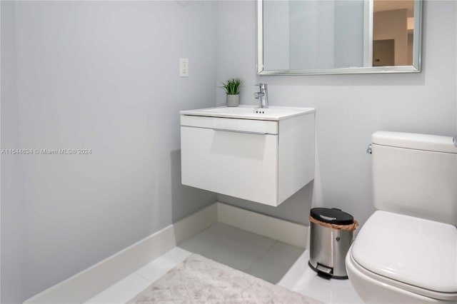 bathroom with vanity, tile floors, and toilet