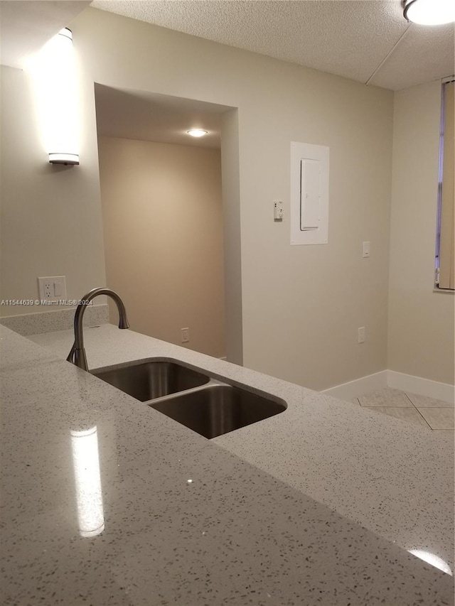 kitchen with sink and light stone countertops