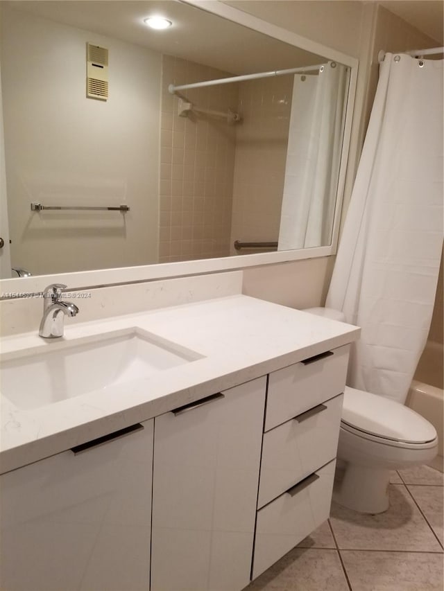 full bathroom with vanity, tile floors, shower / tub combo with curtain, and toilet