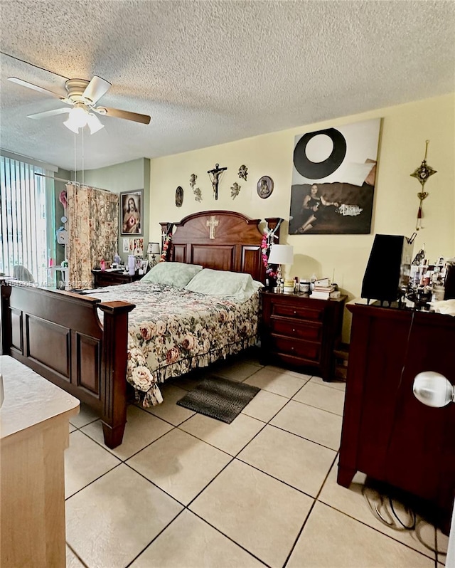 tiled bedroom with a textured ceiling and ceiling fan