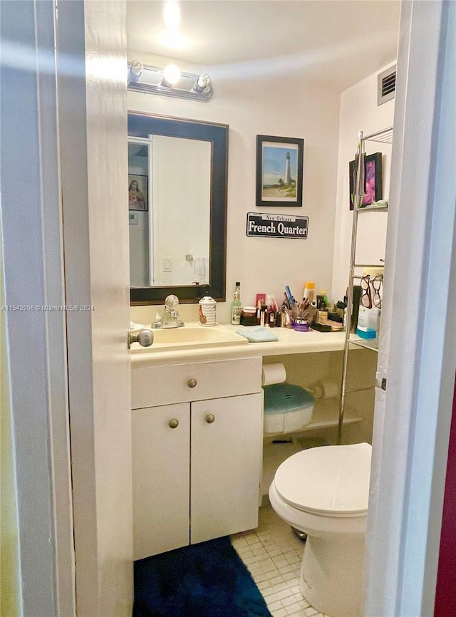 bathroom featuring vanity and toilet