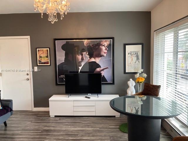 interior space with an inviting chandelier and light hardwood / wood-style flooring