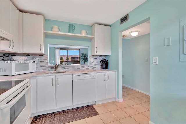 kitchen with white cabinetry, sink, white appliances, light tile patterned flooring, and decorative backsplash