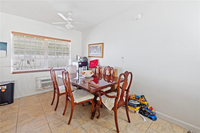 tiled dining area featuring an AC wall unit and ceiling fan