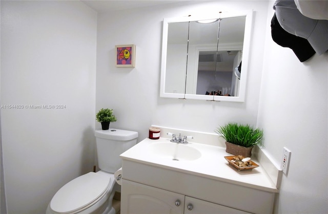 bathroom with toilet and oversized vanity