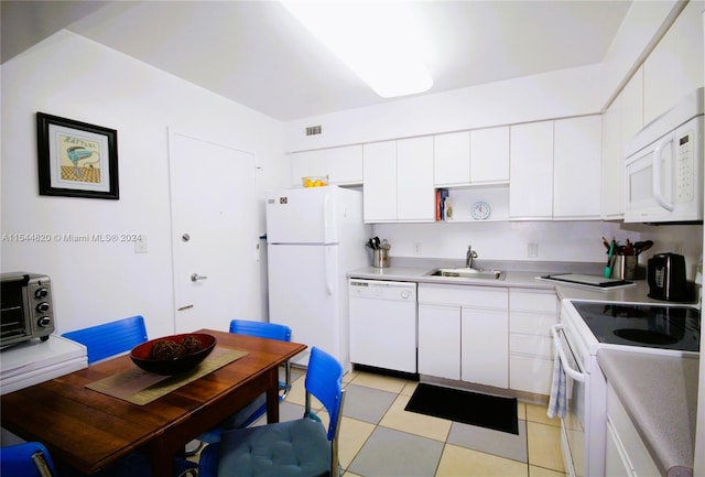 kitchen featuring white appliances, white cabinets, sink, and light tile floors