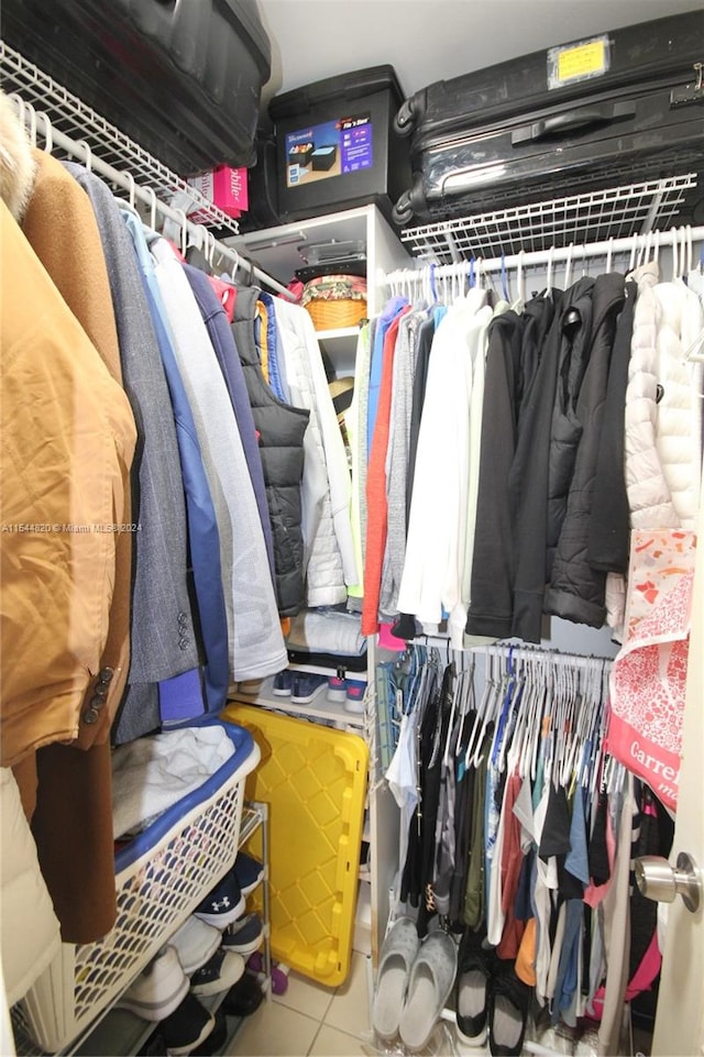 spacious closet featuring tile flooring