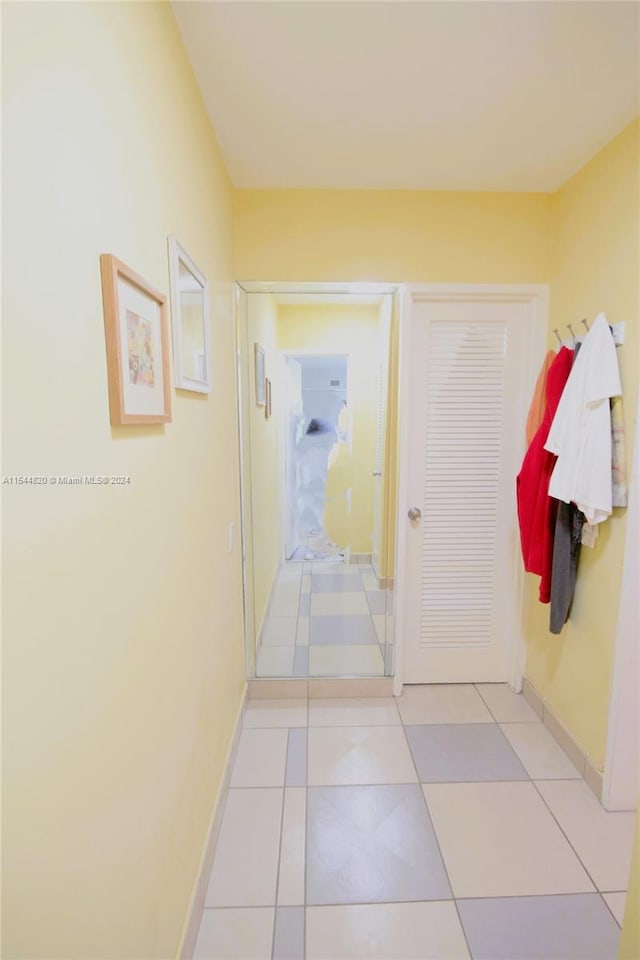 hall featuring light tile flooring