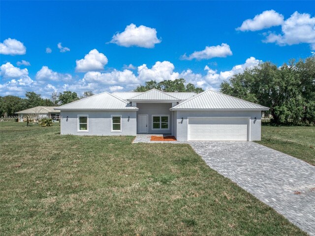 view of front of property with a garage and a front lawn