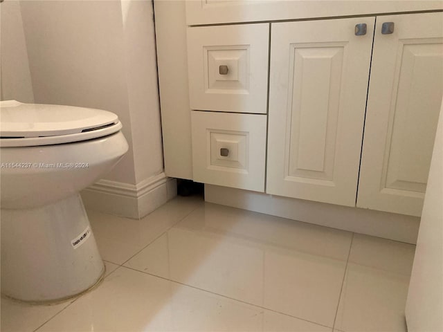 bathroom with tile patterned flooring and toilet