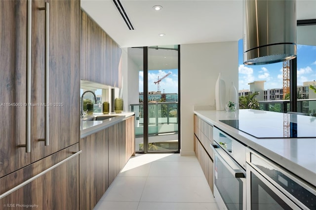 9901 W Bay Harbor Dr Unit 303, Bay Harbor Islands, FL 33154 - kitchen featuring modern cabinets, paneled refrigerator, white oven, light countertops, and black electric cooktop