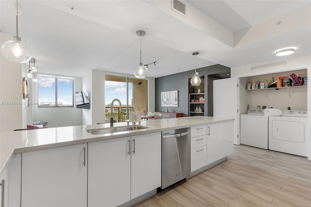 kitchen featuring washer and clothes dryer, sink, white cabinets, and dishwasher