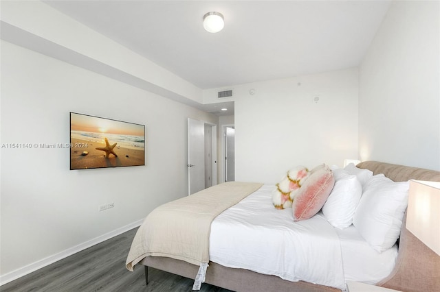 bedroom with dark hardwood / wood-style flooring