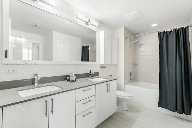 full bathroom with toilet, double sink, tile floors, shower / bathtub combination with curtain, and large vanity