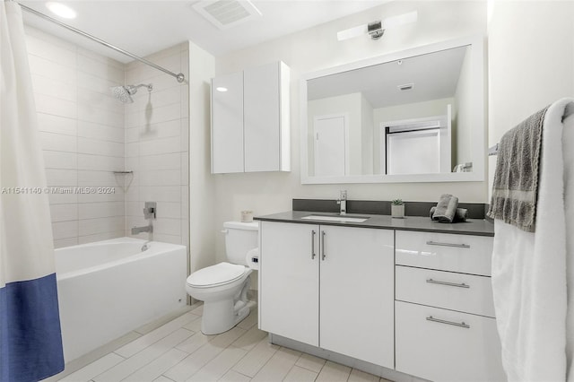 full bathroom with toilet, large vanity, shower / tub combo, and tile flooring