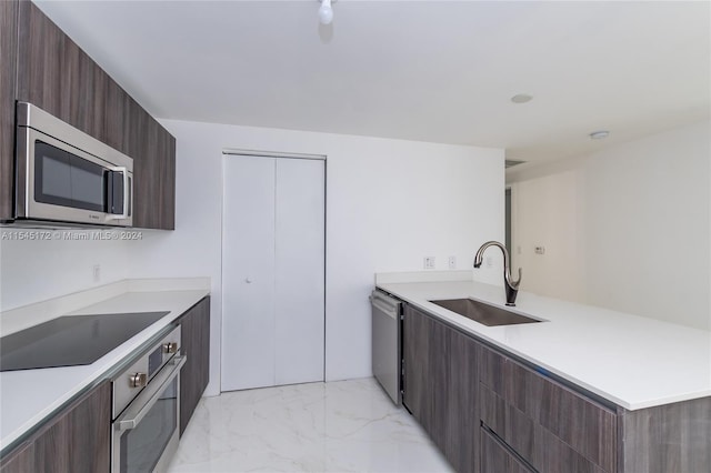 kitchen with sink, dark brown cabinets, and appliances with stainless steel finishes