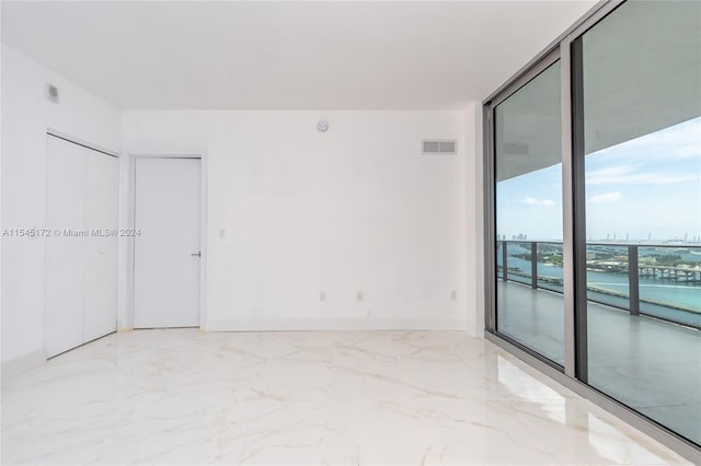 unfurnished room featuring floor to ceiling windows