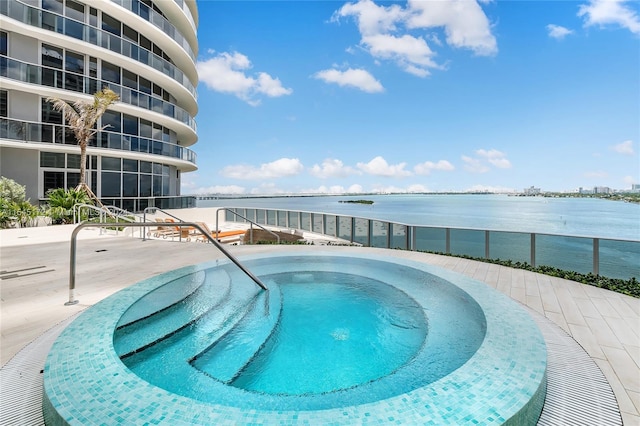 view of pool with a water view