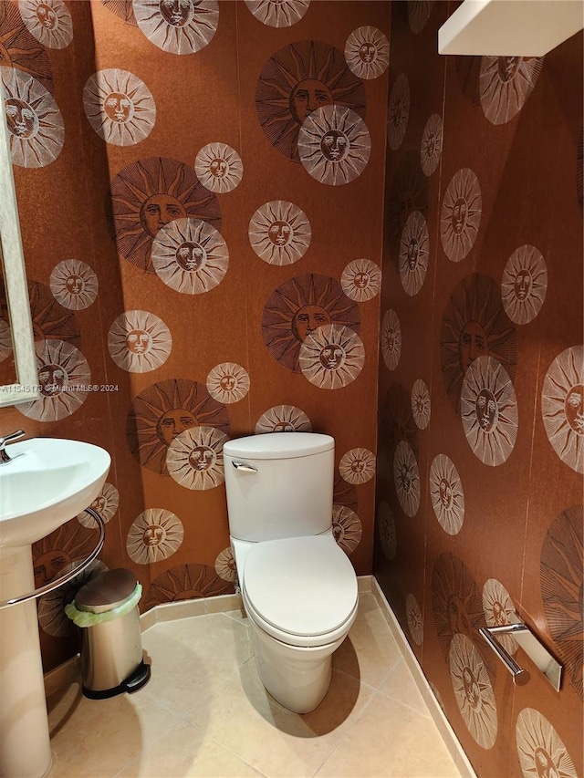 bathroom featuring tile floors and toilet