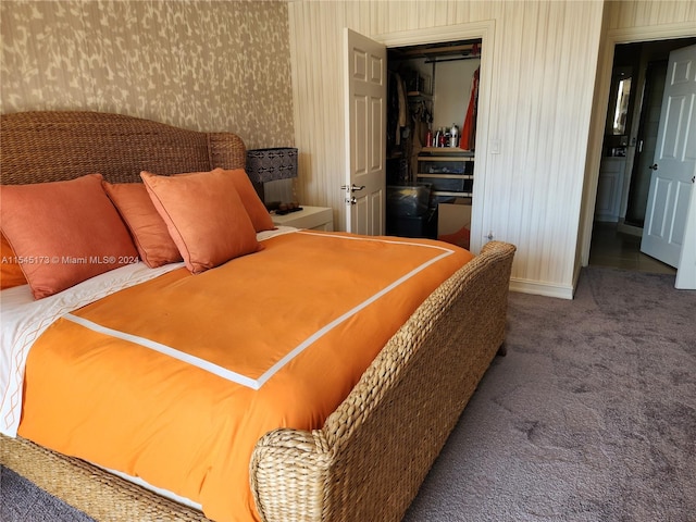 bedroom featuring a closet and dark colored carpet