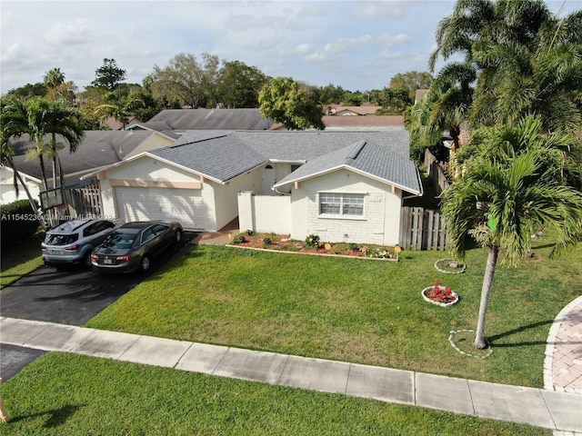 ranch-style house with a garage and a front yard