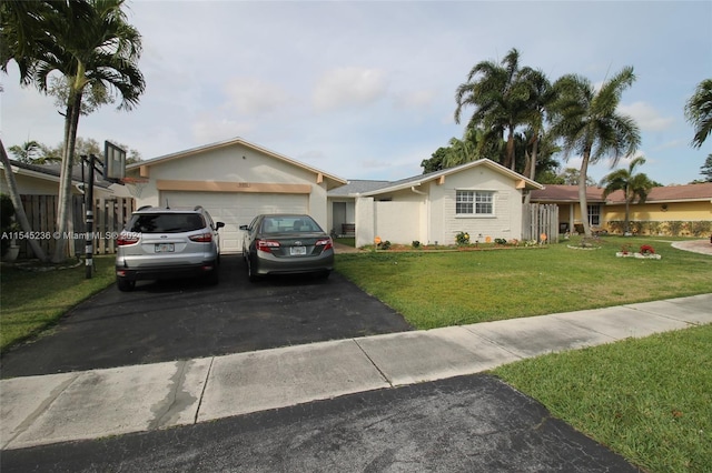 ranch-style home with a front lawn and a garage