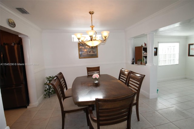 dining room featuring light tile patterned floors, ornate columns, and ornamental molding