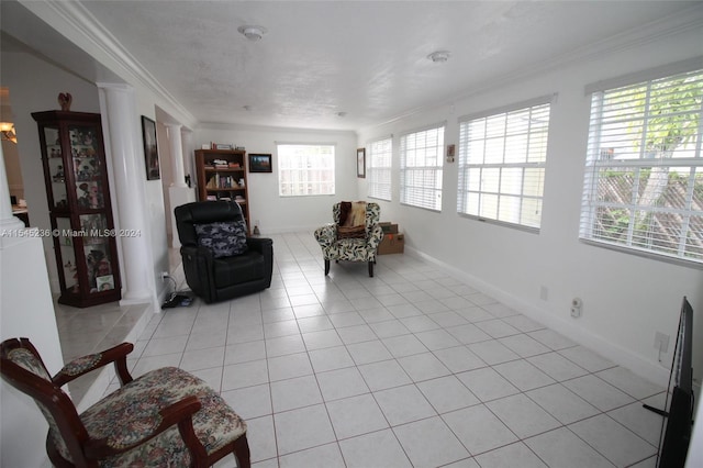 living area with light tile patterned floors and ornamental molding