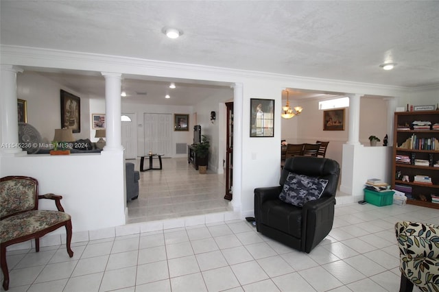 tiled living room with a chandelier, a textured ceiling, and ornamental molding