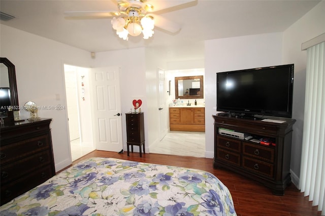 bedroom featuring connected bathroom, ceiling fan, sink, and wood-type flooring