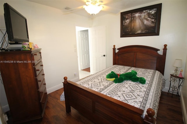 bedroom with ceiling fan and dark wood-type flooring