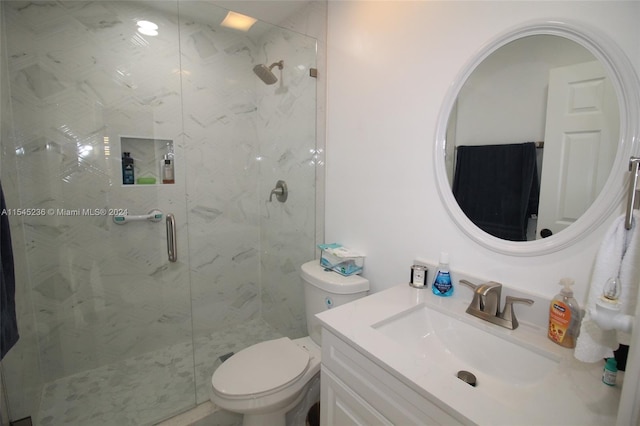 bathroom featuring vanity, toilet, and a shower with door