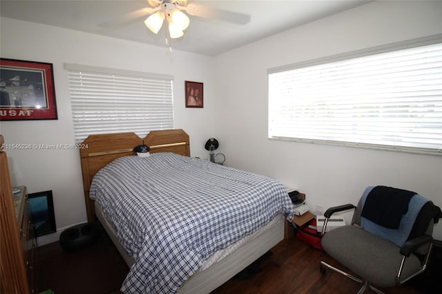 bedroom with ceiling fan, dark wood-type flooring, and a baseboard radiator