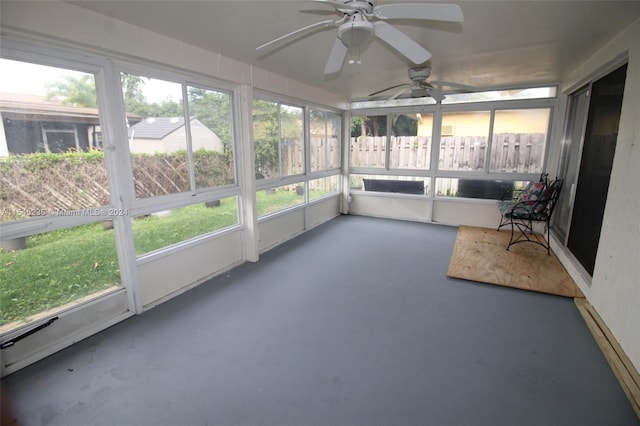 unfurnished sunroom with ceiling fan