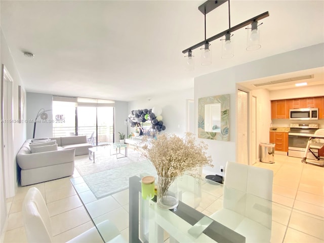 tiled dining room featuring expansive windows