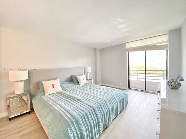 bedroom featuring access to exterior and light hardwood / wood-style flooring