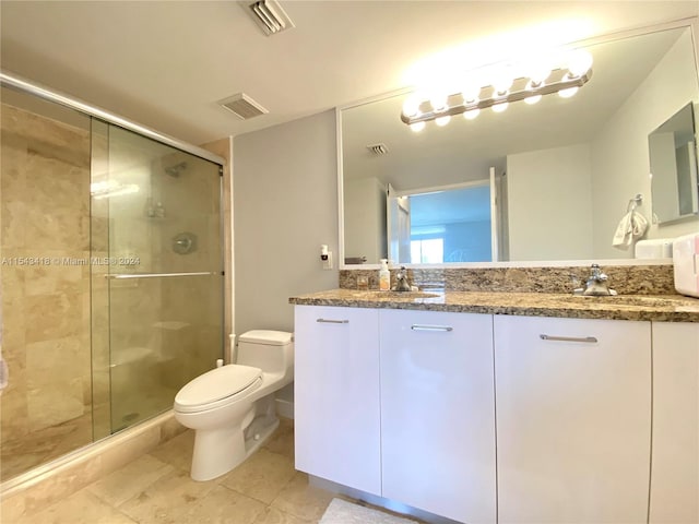 bathroom featuring toilet, double vanity, tile floors, and walk in shower