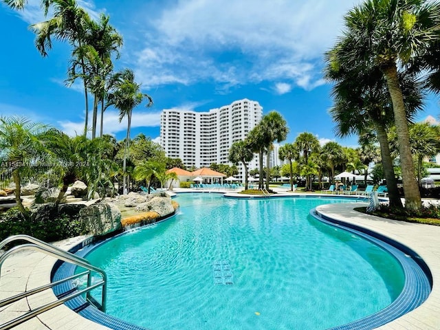 view of swimming pool with pool water feature