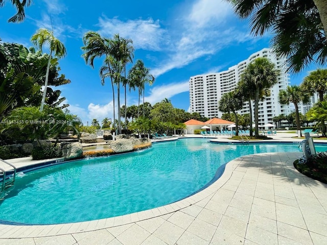 view of swimming pool with pool water feature