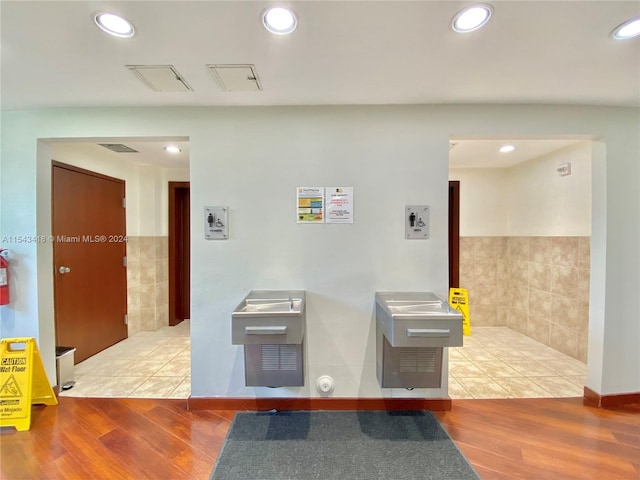 interior space featuring tile walls and light hardwood / wood-style floors