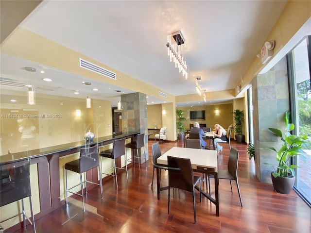 dining space with dark hardwood / wood-style flooring