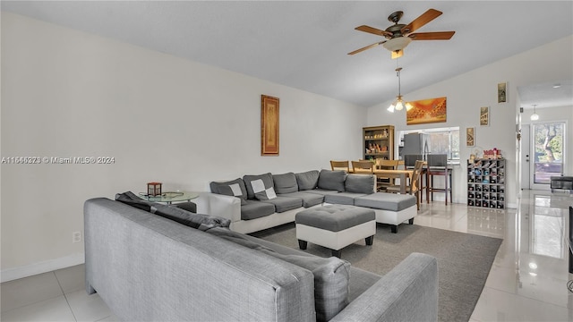 tiled living room featuring ceiling fan and lofted ceiling