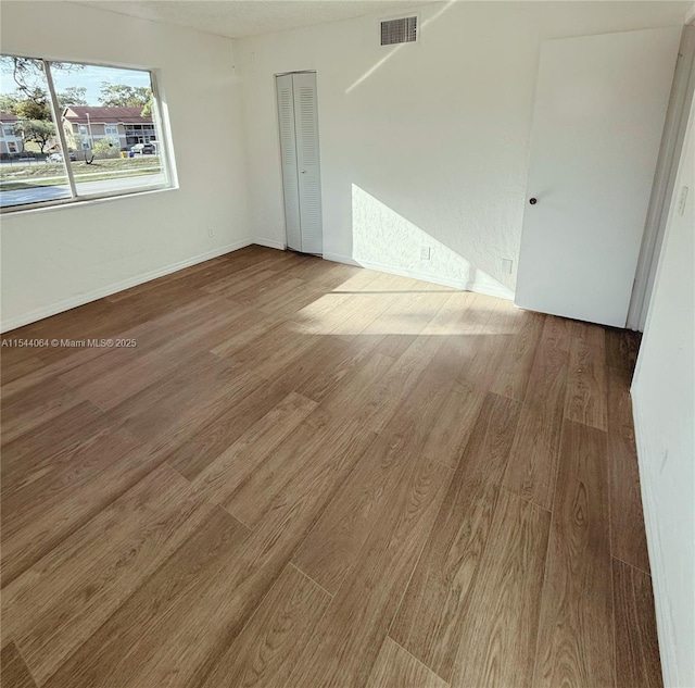 unfurnished room featuring hardwood / wood-style floors