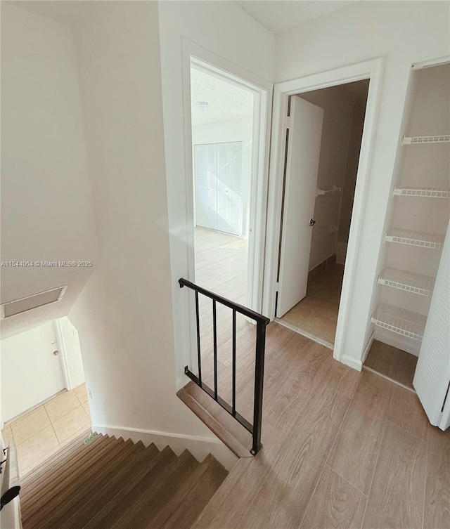 stairway featuring wood-type flooring