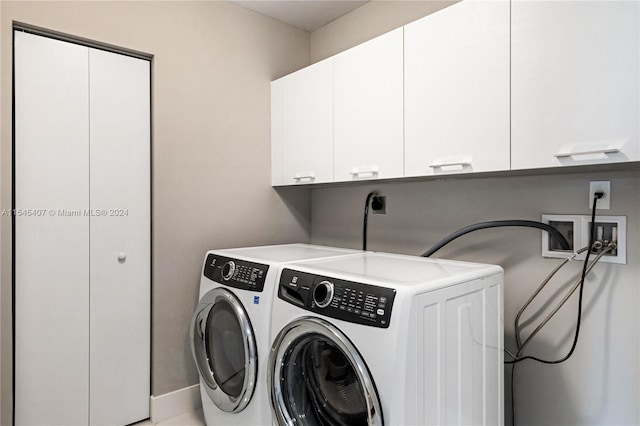 clothes washing area with washing machine and clothes dryer, washer hookup, cabinets, and hookup for an electric dryer