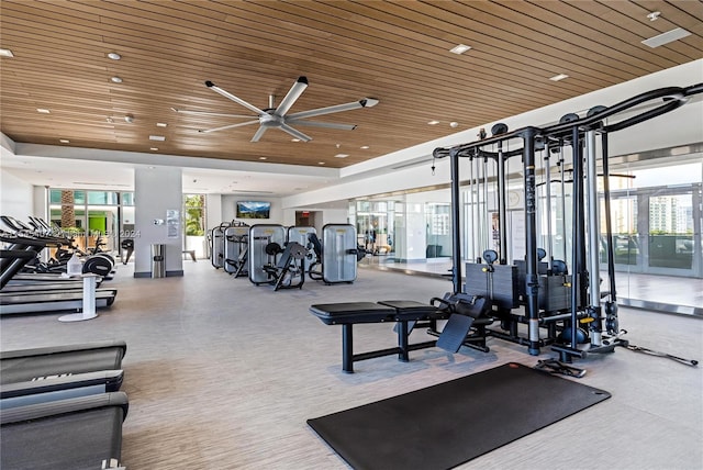 workout area featuring wood ceiling and ceiling fan