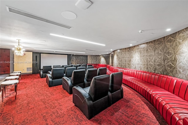 carpeted home theater featuring a notable chandelier